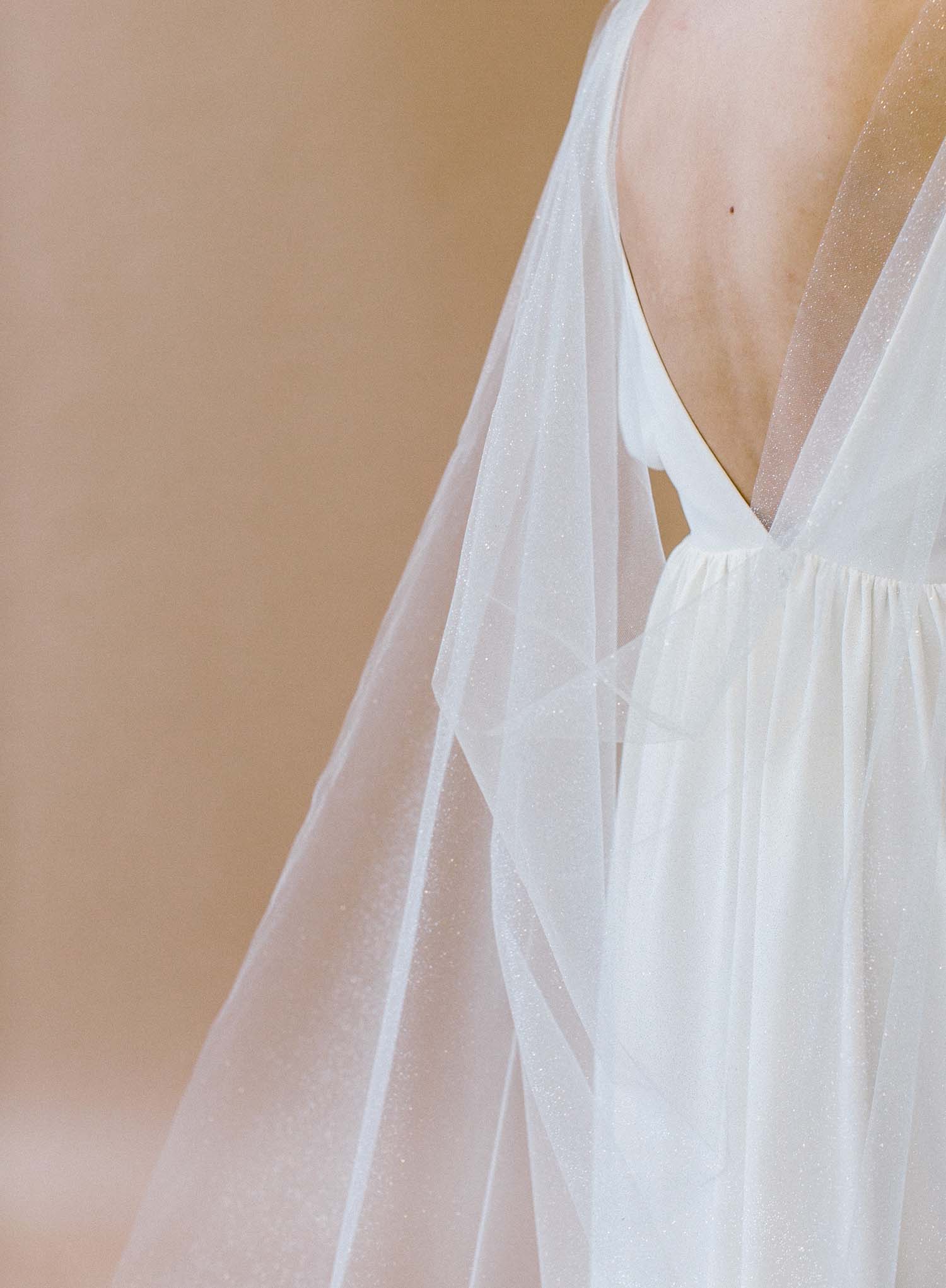 Modern bridal cape veil with subtle shimmer tulle