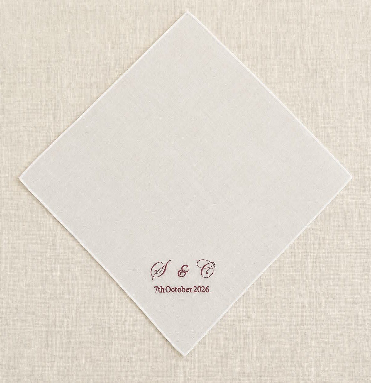 Close-up of embroidered wedding handkerchief featuring personalised initials and wedding date