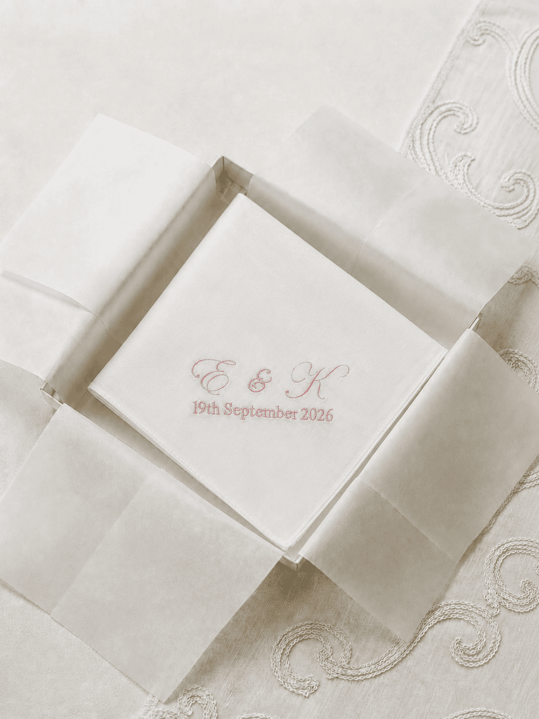 Close-up of embroidered wedding handkerchief featuring personalised initials and wedding date